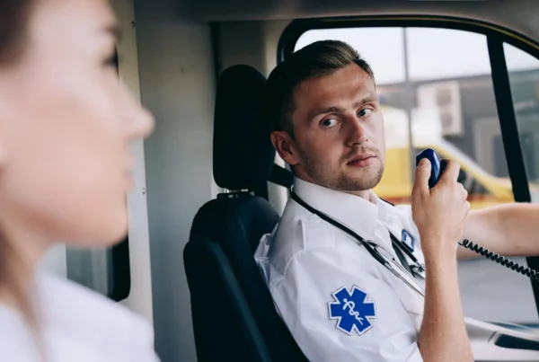A Paramedic Using a Two Way Radio in an Ambuiance