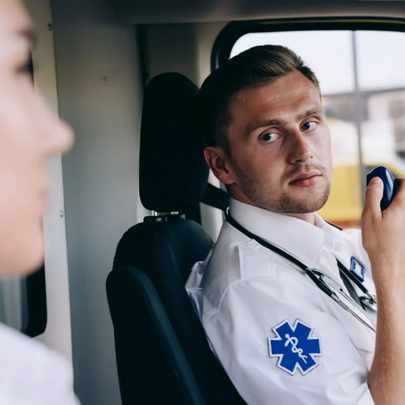 A Paramedic Using a Two Way Radio in an Ambuiance